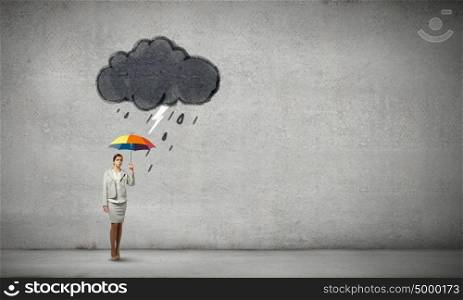 Businesswoman with umbrella. Young businesswoman with colorful umbrella under black cloud