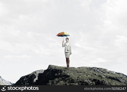 Businesswoman with umbrella. Young pretty businesswoman in suit with colorful umbrella