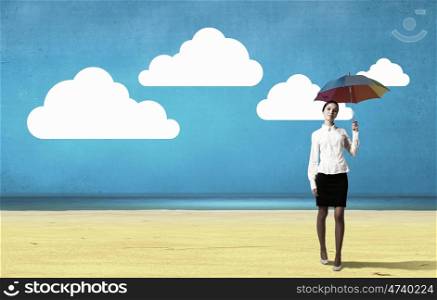 Businesswoman with umbrella. Young pretty businesswoman with colorful umbrella on drawn background