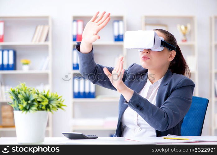 Businesswoman with virtual reality glasses in office