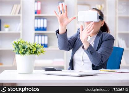 Businesswoman with virtual reality glasses in office