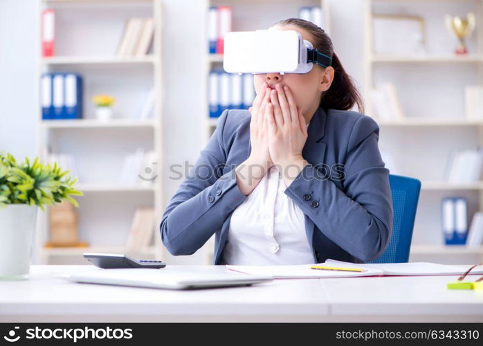 Businesswoman with virtual reality glasses in office