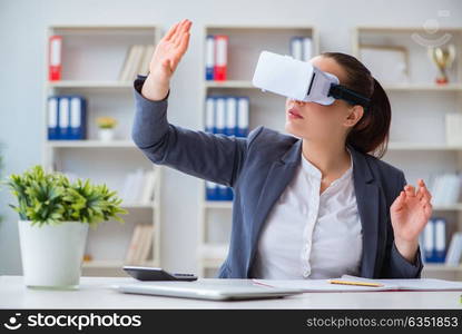 Businesswoman with virtual reality glasses in office