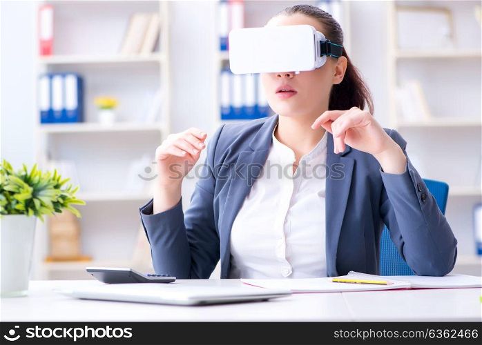 Businesswoman with virtual reality glasses in office