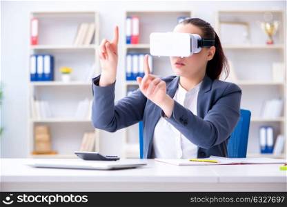 Businesswoman with virtual reality glasses in office. The businesswoman with virtual reality glasses in office