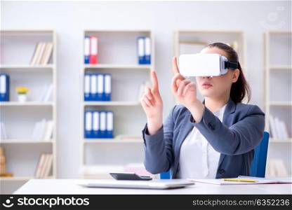 Businesswoman with virtual reality glasses in office. The businesswoman with virtual reality glasses in office