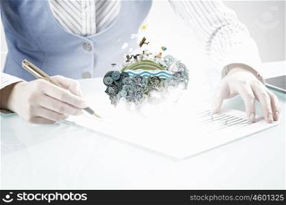 Businesswoman working at desk. Young businesswoman writing document in office. Elements of this image are furnished by NASA