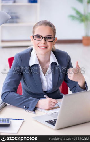 Businesswoman working at her desk in office