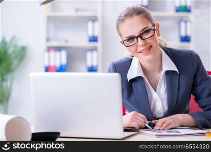 Businesswoman working at her desk in office