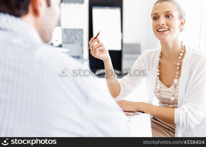 Businesswoman working in office. Happy businesswoman in office with her colleague