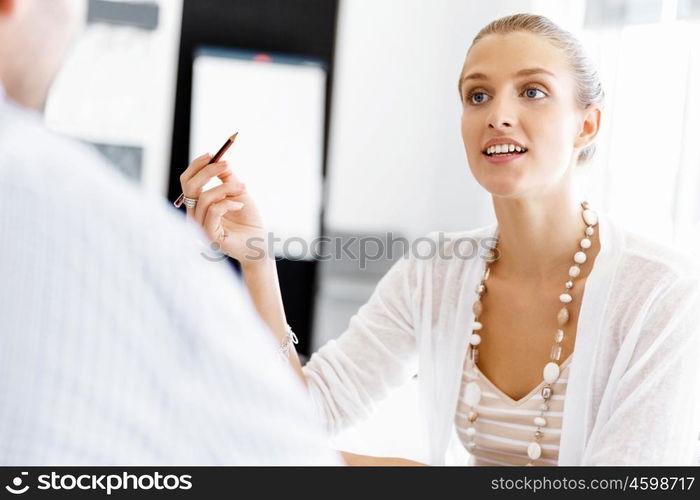 Businesswoman working in office. Happy businesswoman in office with her colleague