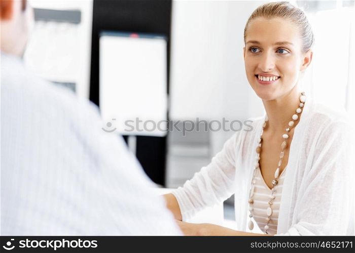 Businesswoman working in office. Happy businesswoman in office with her colleague