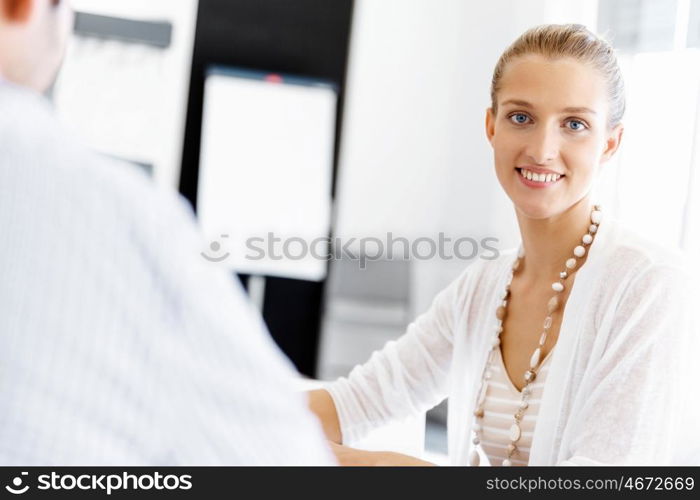 Businesswoman working in office. Happy businesswoman in office with her colleague