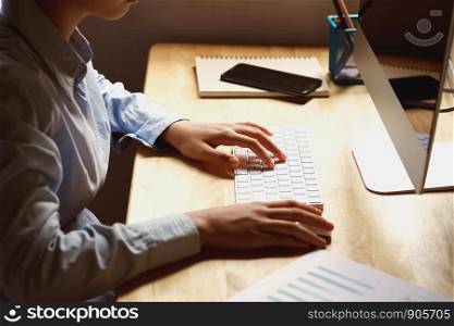 businesswoman working on desk using laptop for check data of finance in office
