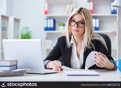 Businesswoman working on laptop at the desk in the office