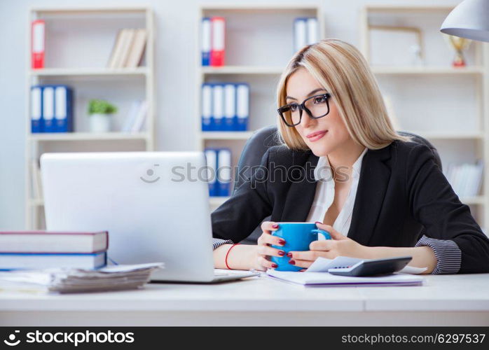 Businesswoman working on laptop at the desk in the office