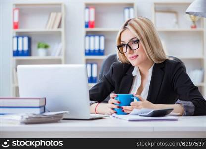Businesswoman working on laptop at the desk in the office