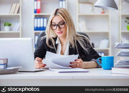 Businesswoman working on laptop at the desk in the office