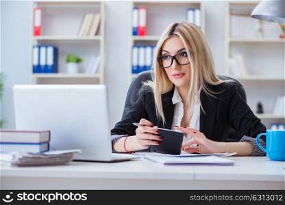 Businesswoman working on laptop at the desk in the office