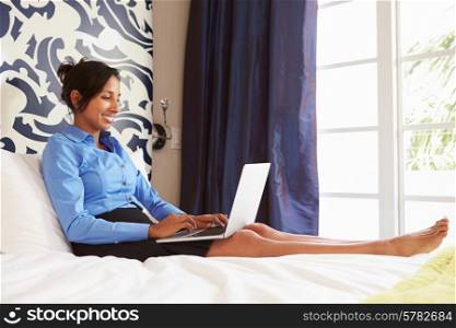 Businesswoman Working On Laptop In Hotel Room