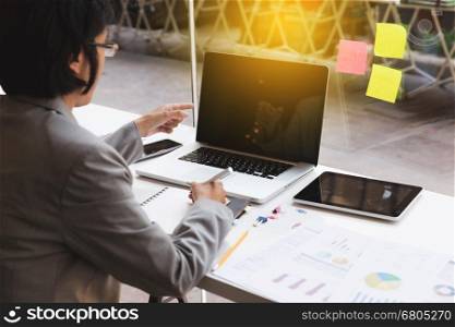 businesswoman working with document and laptop computer for use as office workplace concept
