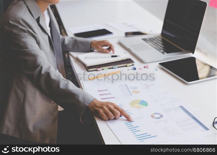 businesswoman working with document and laptop computer for use as office workplace concept