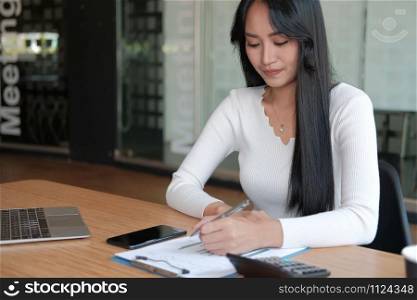 businesswoman working with document at office. woman startup entrepreneur analyzing financial performance at workplace. student studying doing assignment