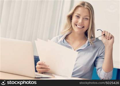 Businesswoman working with papers in offfice