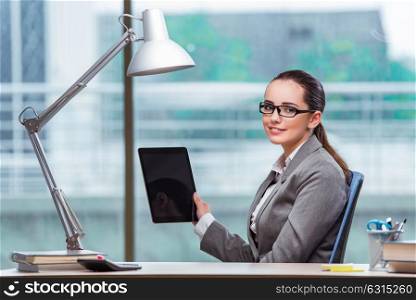 Businesswoman working with tablet computer in business concept