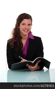 Businesswoman writing in journal