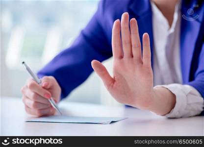 Businesswoman writing notes at desk