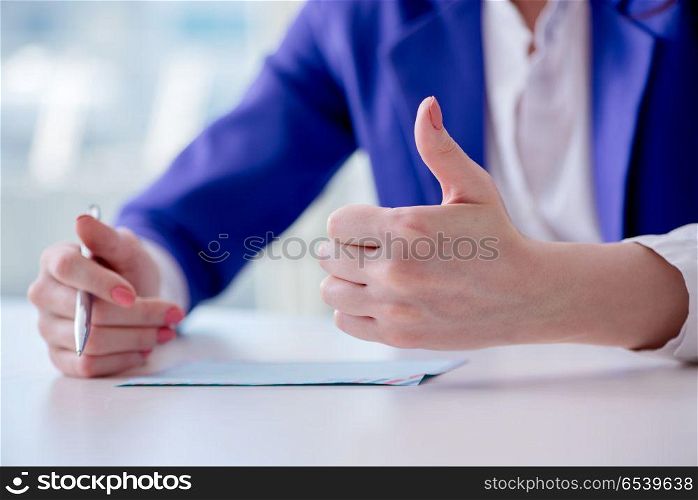 Businesswoman writing notes at desk