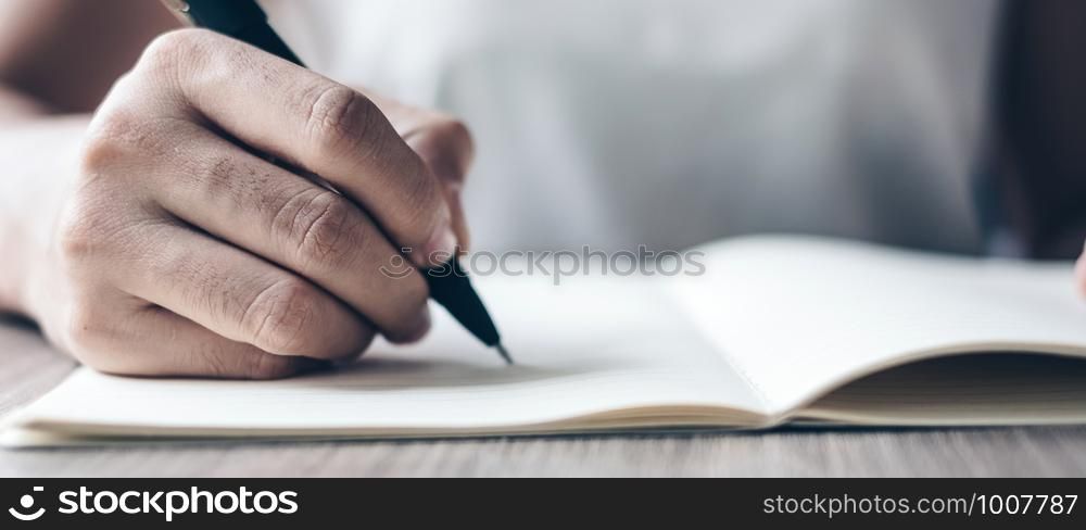 Businesswoman writing on notebook in office, hand of woman holding pen with signature on paper report. business concepts