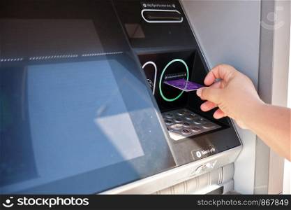 Businesswoman wtihdrawing money from bank atm for transaction. Bank ATM transaction