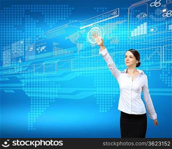BusinesswomBusinesswoman standing and working wth touch screen technologyan and touch screen technology