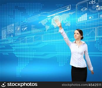 BusinesswomBusinesswoman standing and working wth touch screen technologyan and touch screen technology