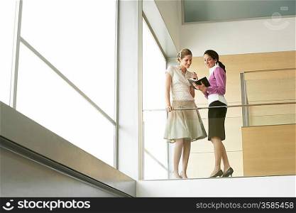 Businesswomen Conversing on Mezzanine