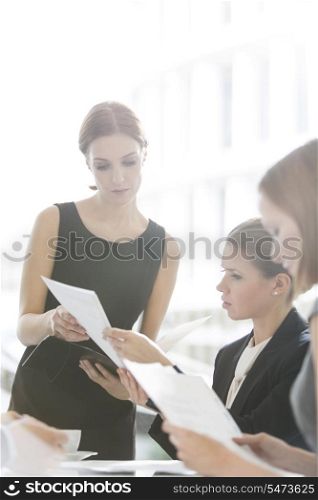 Businesswomen doing paperwork during coffee break