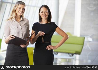 Businesswomen Having Informal Meeting In Modern Office
