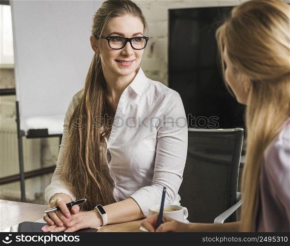 businesswomen having meeting indoors