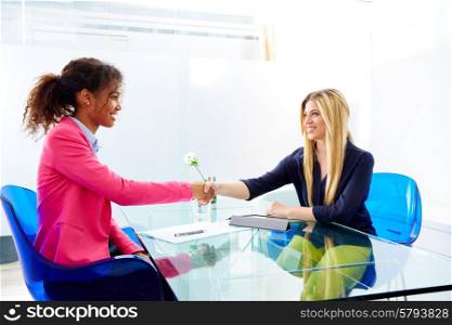 businesswomen interview handshake multi ethnic africand and blond sitting at office