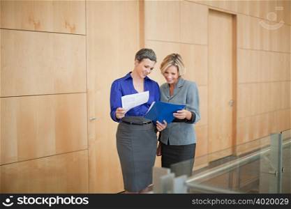 Businesswomen looking at paperwork