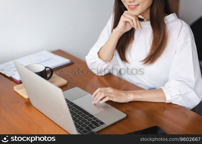 Businesswomen reading data on laptop to thinking about new startup while working in outside office.