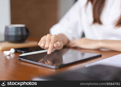 Businesswomen researching data and reading finance data on tablet while analysis about new startup.