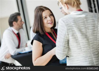 Businesswomen talking during coffee break at convention center