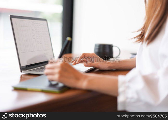 Businesswomen use digital tablet with stylus pen and analysis finance data of new startup on laptop.