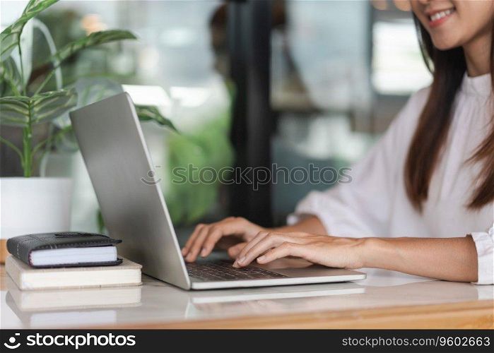 Businesswomen use laptop to typing financial data on keyboard and working about new startup project.