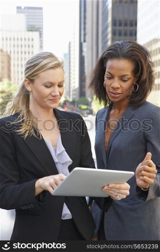 Businesswomen Using Digital Tablet Outside Office