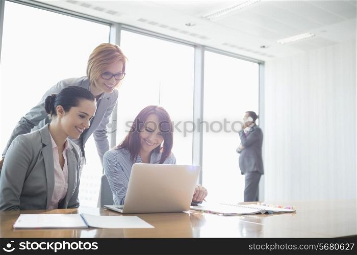 Businesswomen using laptop in office