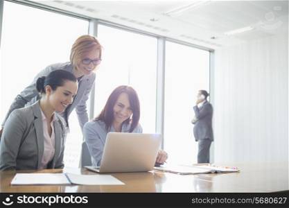 Businesswomen using laptop in office